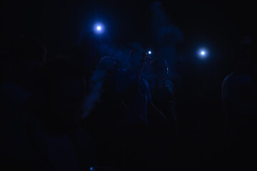 Rock concert, silhouettes of happy people raising their hands, rock concert, music festival, New Year celebration, nightclub party, dance floor, disco club