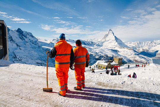 Workers enjoying the view of the mighty Matterhorn from Gornergrat on a sunny winter morning. 