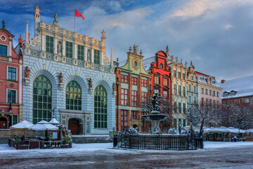 Sunrise in the historic center of Gdansk with the Neptune fountain at winter, Poland.