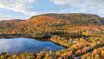 Maine - New England fall foliage at a lake with sunset autumn colors