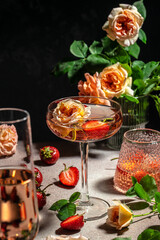 pink wine with strawberries in glasses, vertical image. top view. place for text