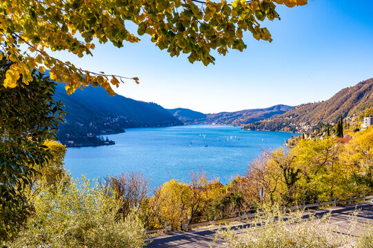 Panorama of Lake Como and the shore of Como, with villages and mountains above.
