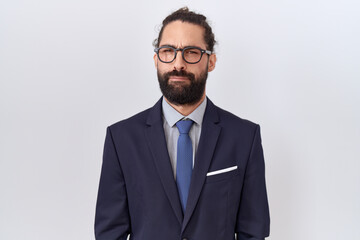 Hispanic man with beard wearing suit and tie skeptic and nervous, frowning upset because of problem. negative person.