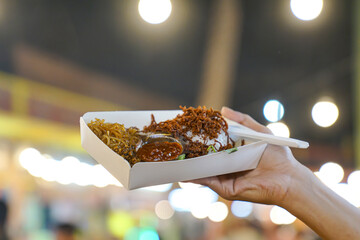 Close up of shredded beef rice and side dishes with a background of bokeh lights