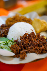 Close up of rice, shredded empal meat and side dishes, nasi daging empal suwir