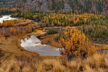 Russia, Gorny Altai. View from the mountain pass to the autumn Chuya River along the Chuya tract in the area of the North Chuya mountain range.