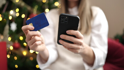 Young beautiful hispanic woman doing christmas online shopping with smartphone at home