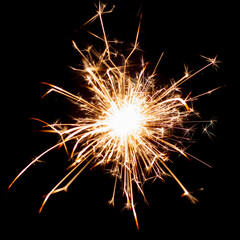 Sparklers on black isolated background. Sparks from a burning sparkler. To insert an image in a...