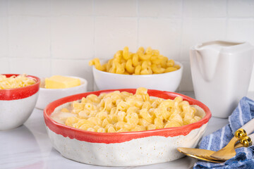 Creamy mac and cheese with ingredients for cooking