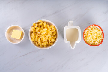 Creamy mac and cheese with ingredients for cooking
