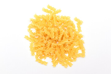 A Heap of Uncooked Fusilli Pasta Scattered on White Table. Raw and Dry Macaroni. Unhealthy and Fat Food. Italian Culture