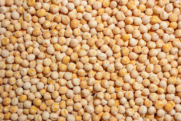 Uncooked Yellow Polished Peas Background. A Culinary Canvas of Dry Yellow Peas, Creating a Lively and Textured Background for Gourmet Cooking. Scattered Raw Polished Peas. Healthy Eating Ingredients