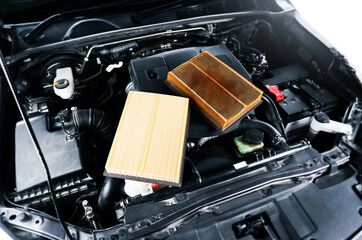 Comparison of car air filters , new filters and clogged filters on cover engine in car engine...