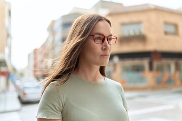 Young beautiful woman wearing glasses at street