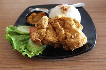 White rice and fried chicken with chili sauce and fresh vegetables are ready to eat