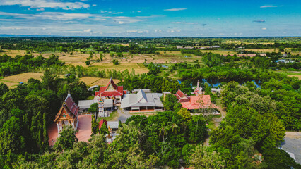 High angle photo, taken with a drone, landscape of the Thai temple area, surrounded by trees,...