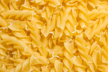 Uncooked Fusilli Pasta: A Culinary Canvas of Spiral Macaroni, Creating a Lively and Textured...