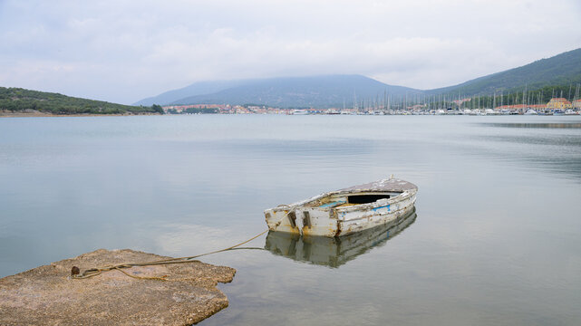 Small shabby boat in a bay of Cres