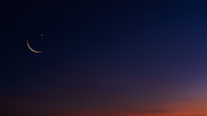 Crescent moon on dark blue twilight sky end of day well space for text Religion of Islamic Ramadan...