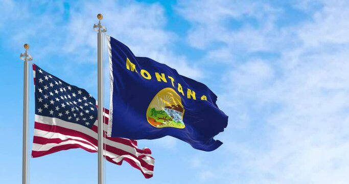 Montana state flag waving in the wind with the American flag on a clear day
