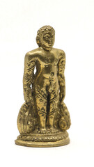 golden jain bahubali statue from a handcrafted collection from an antique shop isolated in a white...