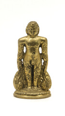 golden jain bahubali statue from a handcrafted collection from an antique shop isolated in a white background