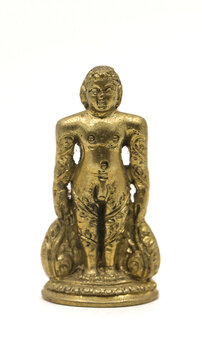 golden jain bahubali statue from a handcrafted collection from an antique shop isolated in a white background