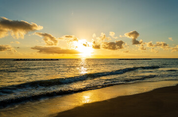 Sunrise over the sea with some Clouds. Golden Hour at the Beach