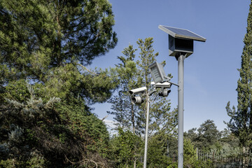 Some posts with surveillance cameras, LED lamps and solar panels with electric energy accumulators