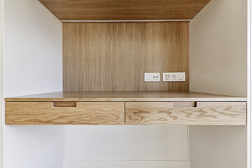 Wooden desk with two drawers and without legs integrated between two white cabinets
