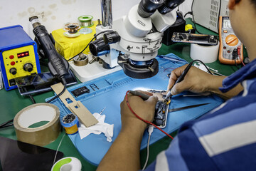 Workbench of a mobile phone repair technician in which working with a device