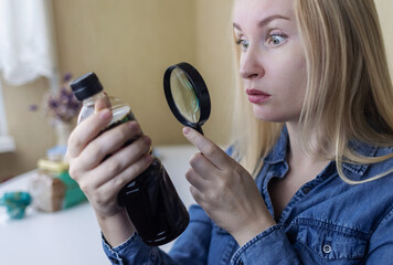 Woman reads instructions for food products at home. Checking labels on goods. Study of product...