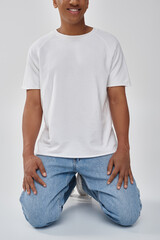 Obraz premium stylish african american man in trendy casual jeans and white t-shirt, copy space for advertising