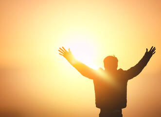 Human hands open palm up worship on sunset sky background. - obrazy, fototapety, plakaty