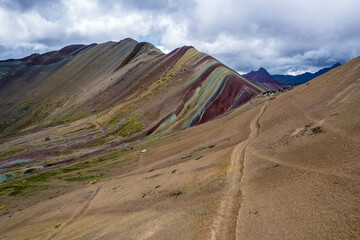 Hiking trail towards Vinicunca in Cusco, Peru with an elevation of over 17,000 ft.  The landscape is known as Rainbow Mountain or Montana de Siete Colores.