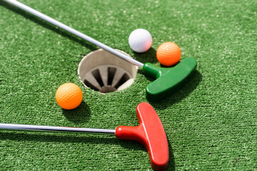 Mini-golf ball on artificial grass. Summer season game