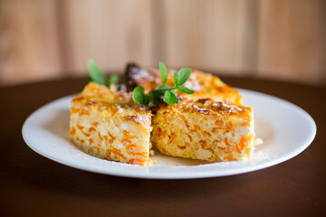 Cooked cottage cheese casserole with pieces of pumpkin inside.