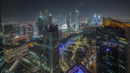 Fototapeta premium Panorama showing futuristic skyscrapers in financial district business center in Dubai night timelapse