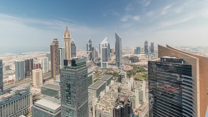 Naklejka na ściany i meble Panorama showing futuristic skyscrapers in financial district business center in Dubai on Sheikh Zayed road timelapse