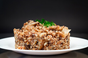 cooked buckwheat boiled with mushroom filling in a plate