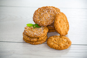 cooked sweet oatmeal cookies on wooden table