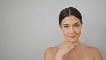 Obraz premium Young beautiful hispanic woman smiling confident touching face over isolated white background