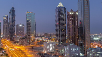 Business bay district skyline with modern architecture night to day timelapse from above.