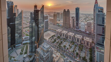 High-rise buildings on Sheikh Zayed Road in Dubai aerial timelapse during sunset, UAE.