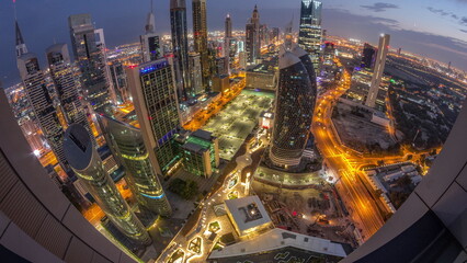 Naklejka premium Skyline panorama of the high-rise buildings on Sheikh Zayed Road in Dubai aerial night to day timelapse, UAE.