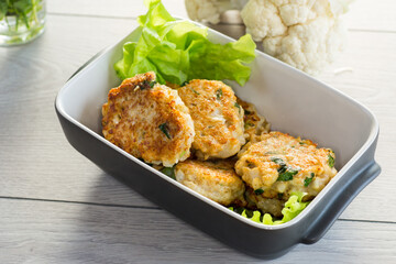 cooked vegetarian fried cauliflower cutlets, in a ceramic form .