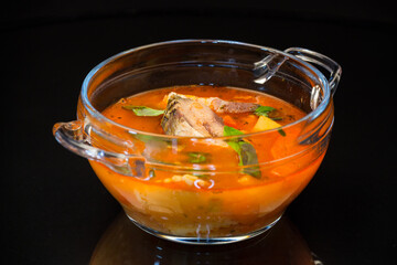 vegetable tomato soup with fish in a plate