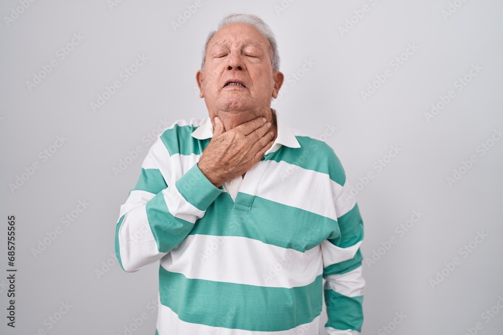 Sticker senior man with grey hair standing over white background touching painful neck, sore throat for flu,