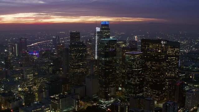 
Beautiful View of Big City Skyline. Blurred brands and Logos in Famous Skyscrapers. Aerial view of Downtown Los Angeles at Sunset. Shot on Helicopter in 8K.
