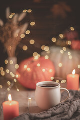 Autumn cozy composition. Tea in a mug, pumpkins and candles